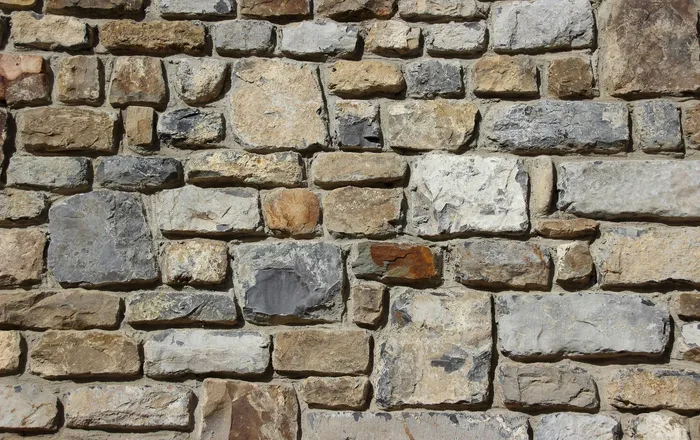 Close view of a dry laid natural stone garden wall, the style of low wall we rebuild in Dundalk, MD