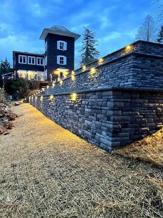 Lit stone retaining wall dusk