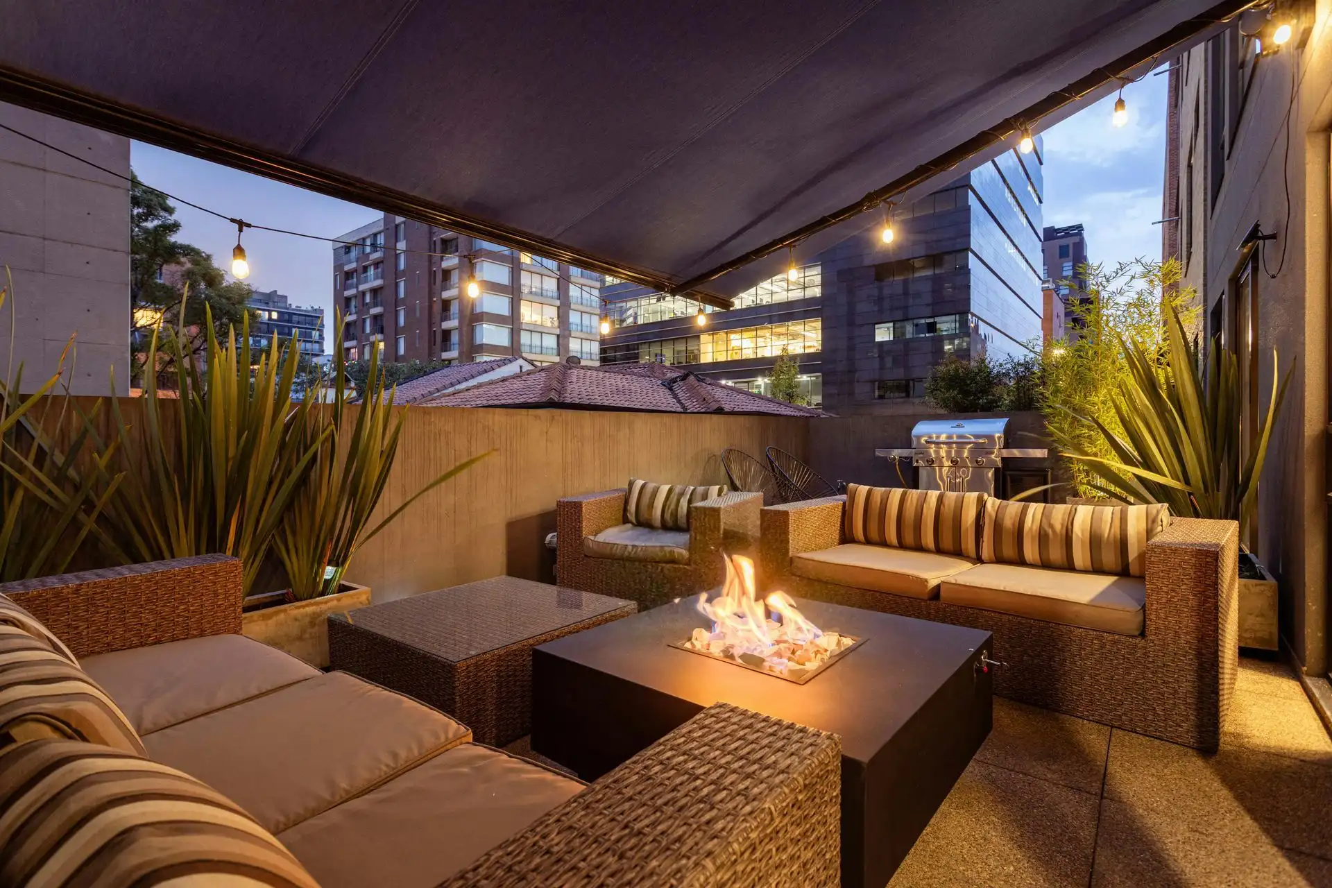 Outdoor lounge fire table string lights
