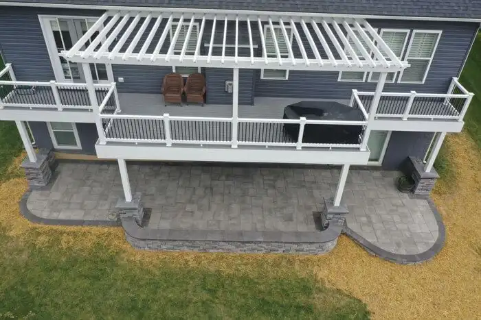 Paver patio under deck white pergola