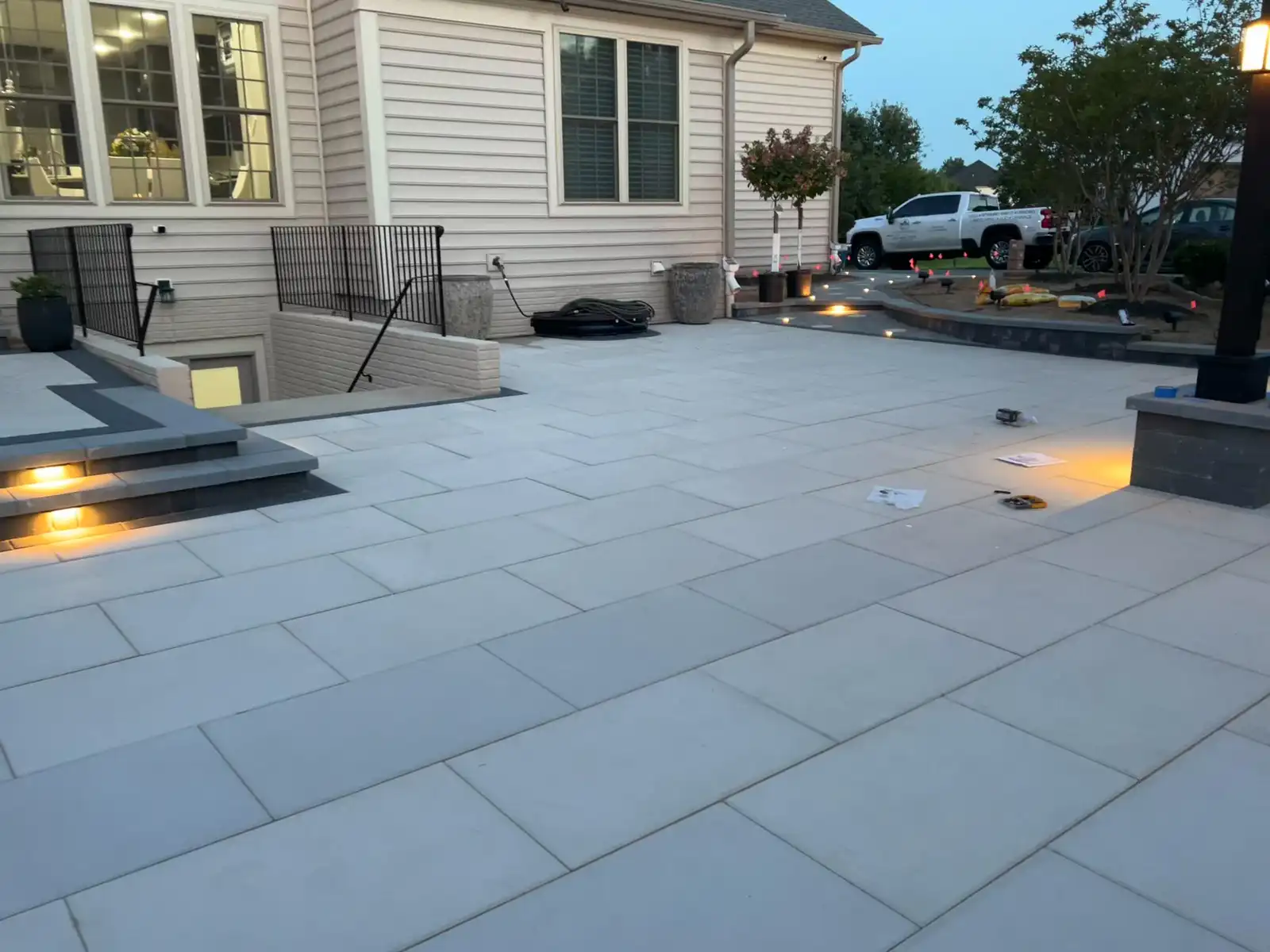 Porcelain paver patio lit steps dusk