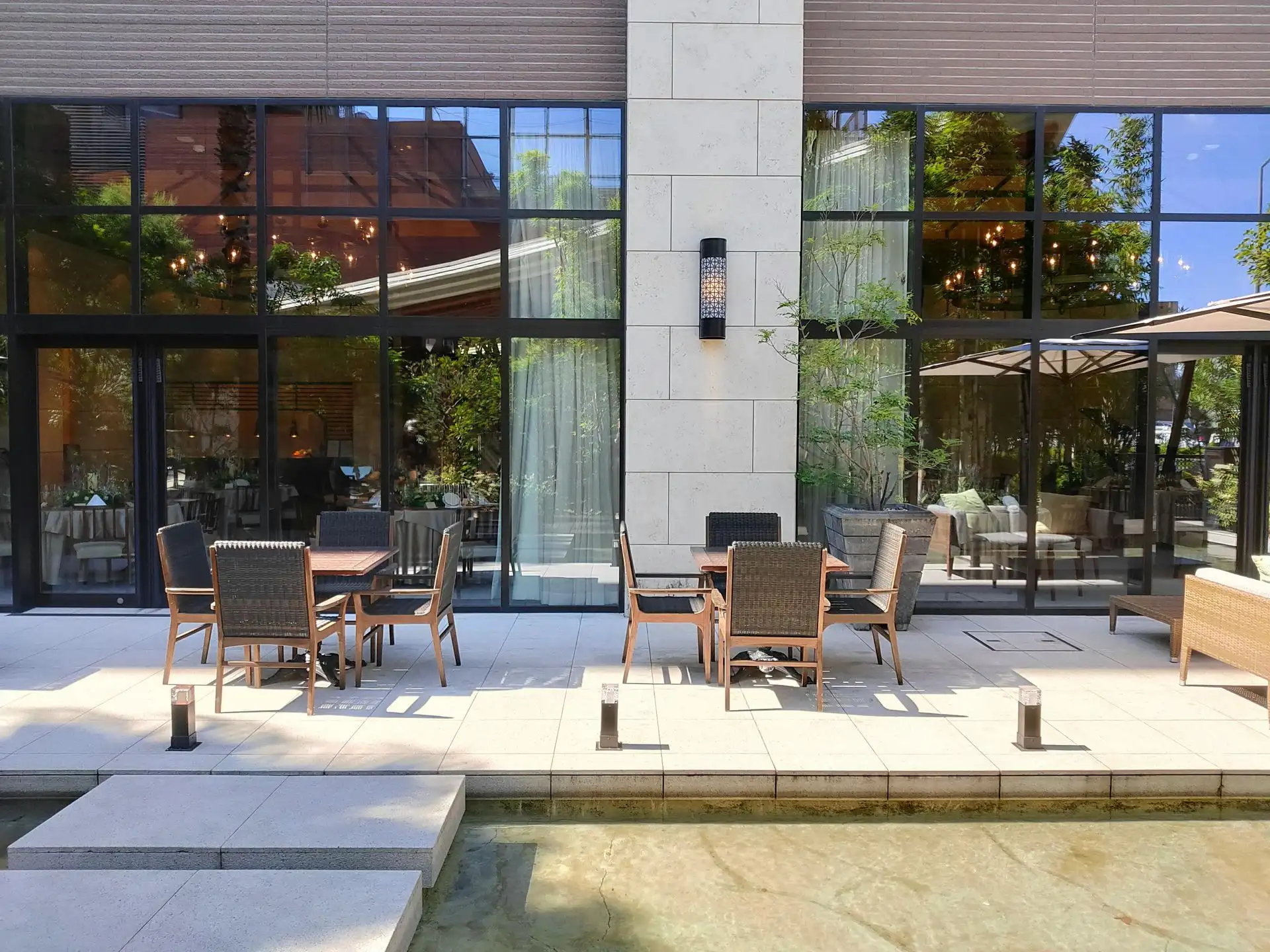 Stone patio dining glass facade
