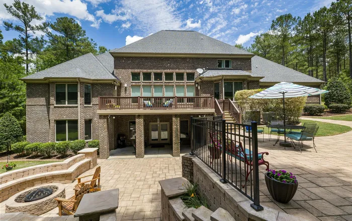 Large format stone paving and a reflecting basin beside a glass facade, echoing Eastport patio restoration in Annapolis, MD